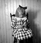 CW2549.jpg      I gammelstua i Våtvika.   Aslaug Våtvik har fått et nytt dukkehode som visstnok ikke fikk noen kropp.    ca. 1922/23.